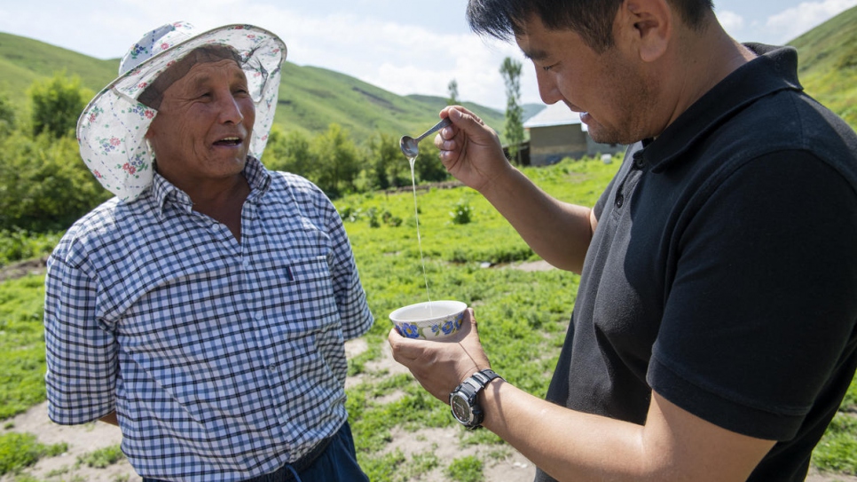 Tasting his honey with lawyer Azizbek Ashurov, who helped him to gain citizenship.