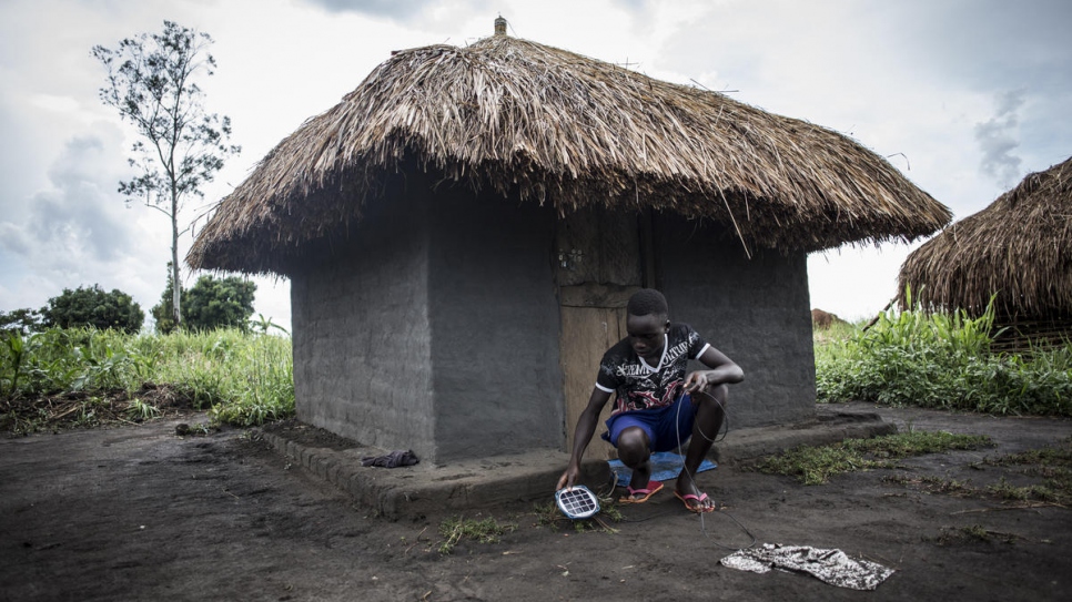 South Sudanese refugee Gift, 14, places charge his self-made solar lamp so he can study at night. Gifted attends school in the Biringi Refugee Settlement in the Democratic Republic of the Congo.