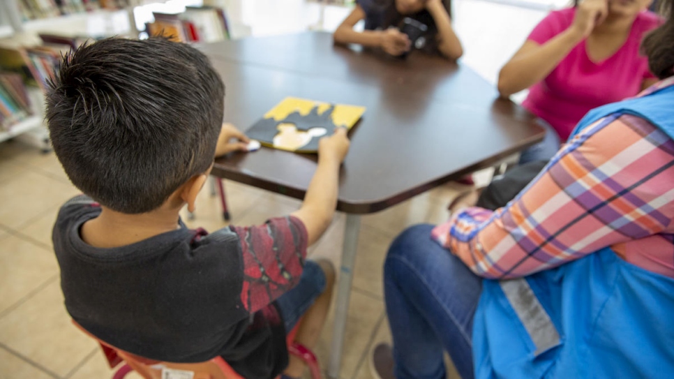 Claudia* and her children Samuel* and Maité* are interviewed by a UNHCR officer at the Biblioparque library in Saltillo, Mexico.