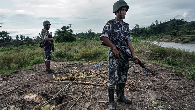 Myanmar border police stand guard in Tinmay village of Buthidaung township, western Myanmar's Rakhine state, July 14, 2017.