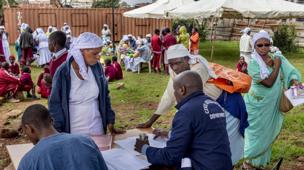 Women from the Shona community wait to have their children registered.