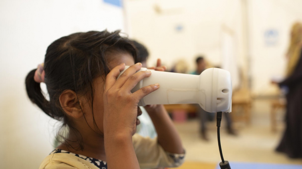 A young Rohingya refugee from Myanmar has her iris scanned as a part of a registration exercise at Kutupalong refugee settlement, Bangladesh.