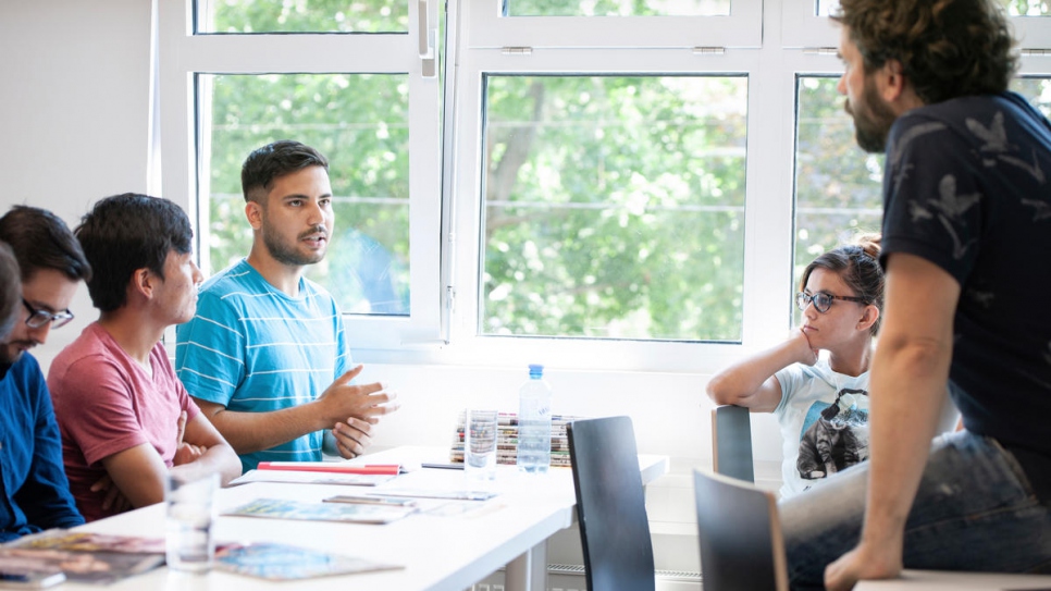 Mortaza Haidari (wearing striped shirt), born in Iran to Afghan parents, talks about his experiences during the media training course.