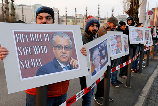 Supporters of Bahraini Sheikh Salman bin Ebrahim Al-Khalifa hold signs reading 
