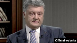Ukrainian President Petro Poroshenko speaks to the 1+1 TV channel in Kyiv on May 12.