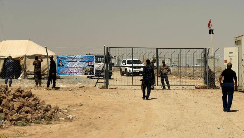Iraqi Security Forces stand guard at the gate of a camp holding families of men suspected of being ISIS affiliates in Bartalla, east of Mosul, Iraq July 15, 2017.
