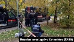Investigative Committee officers work at the scene of Interior Ministry investigator Yevgenia Shishkina's death in the Krasnogorsk district outside Moscow on October 10.