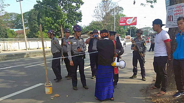 Myanmar police prevent protesters from walking along a public road in Myitkyina, capital of northern Myanmar's Kachin state, April 30, 2018.