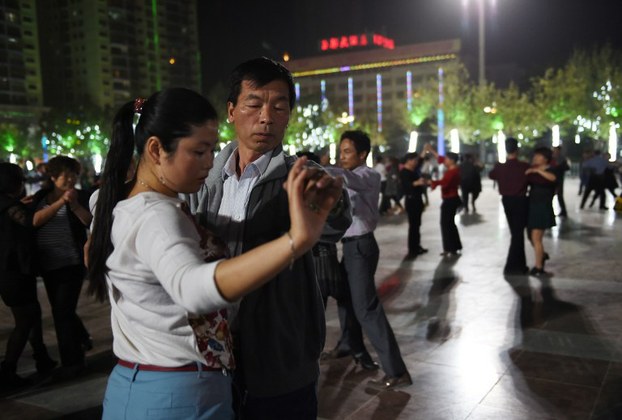 Han Chinese dance in the central square in Hotan, April 15, 2015.