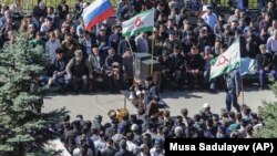 People attend a protest against the land-swap deal agreed by the heads of the Russian regions of Ingushetia and Chechnya in the Ingushetian capital of Magas on October 8.