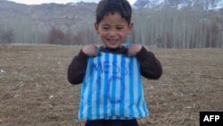 Murtaza Ahmadi, 5, poses with his plastic-bag jersey in January 2016.