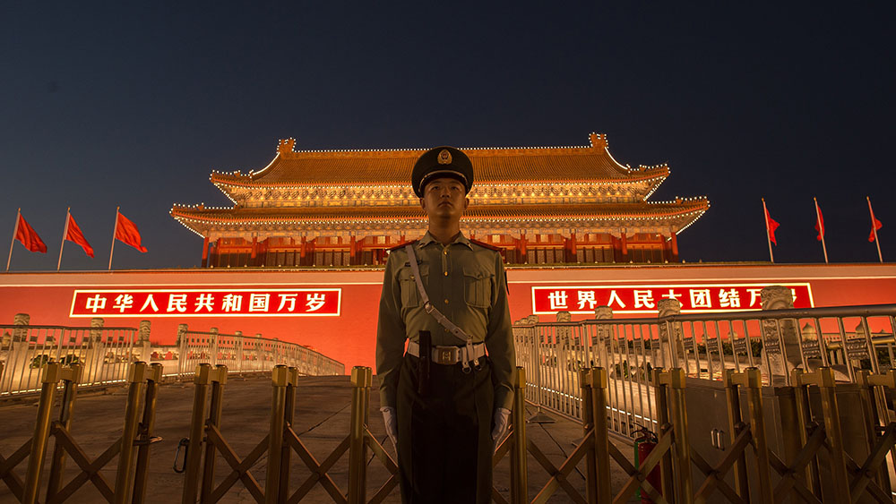 A Chinese paramilitary police officer secures the front gate of the Forbidden City in Beijing, Sept. 28, 2017.