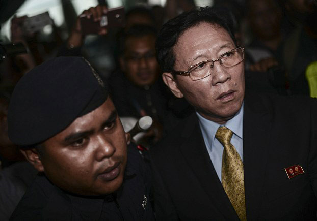 Police escort expelled North Korean Ambassador Kang Chol to the departure hall at Kuala Lumpur International Airport as a he prepares to board a flight out of Malaysia, March 6, 2017.