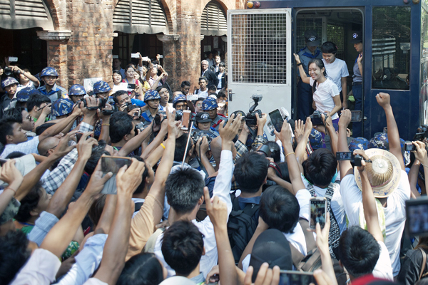 Myanmar student protesters gesture as they arrive at court in the town of Tharrawaddy in Bago region, May 12, 2015.