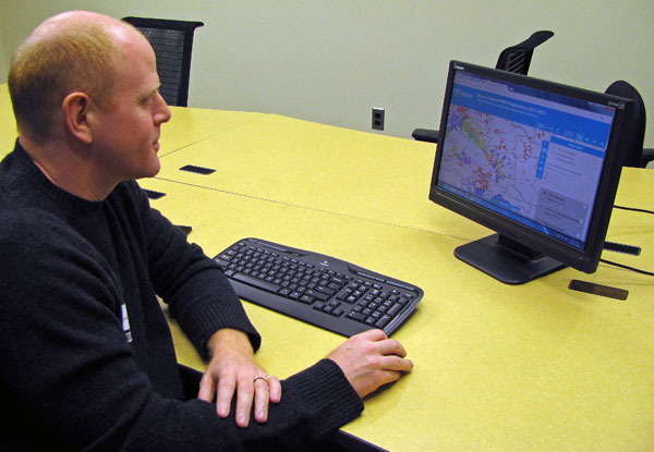 Jonathan Rivers, a technical officer at the World Food Programme, demonstrates the real-time monitoring and evaluation system that he developed for the agency in Cambodia, Dec. 13, 2016.