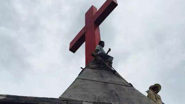 Chinese Christian guards a cross amid a crackdown at a church in Zhejiang province, July 27, 2015.
