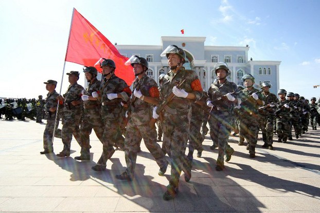 Armed Chinese paramilitary policemen march during an anti-terrorist drill in Xinjiang, July 2, 2013.