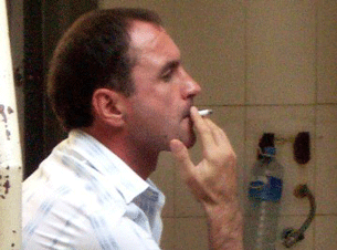 Alexander Trofimov smokes a cigarette after his verdict at the Phnom Penh municipal court, March 14, 2008.
