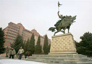 HOHHOT, China: Students approach a statue of Mongolian hero Genghis Khan on the Inner Mongolia University campus, 2006