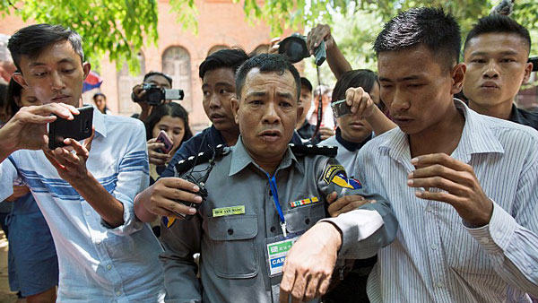 Myanmar Police Captain Moe Yan Naing (C) leaves court during the trial of two detained Reuters journalists in Yangon, April 20, 2018.