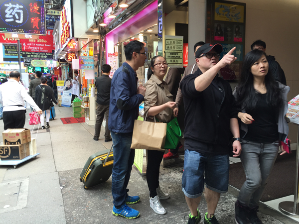 Travelers from mainland China prepare to go shopping in downtown Hong Kong, April 12, 2015.