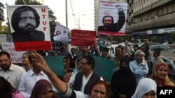 Pakistani human rights activists hold images of missing activist Salman Haider during a protest in Karachi.