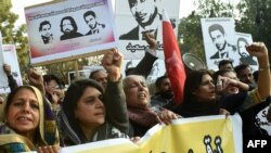 Pakistani rights activists hold up pictures of bloggers who have disappeared during a protest in Lahore in January 2017.