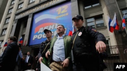 Russian police detain a man during a protest against the city's plan to knock down Soviet-era apartment blocs in front of the State Duma in central Moscow on June 9.