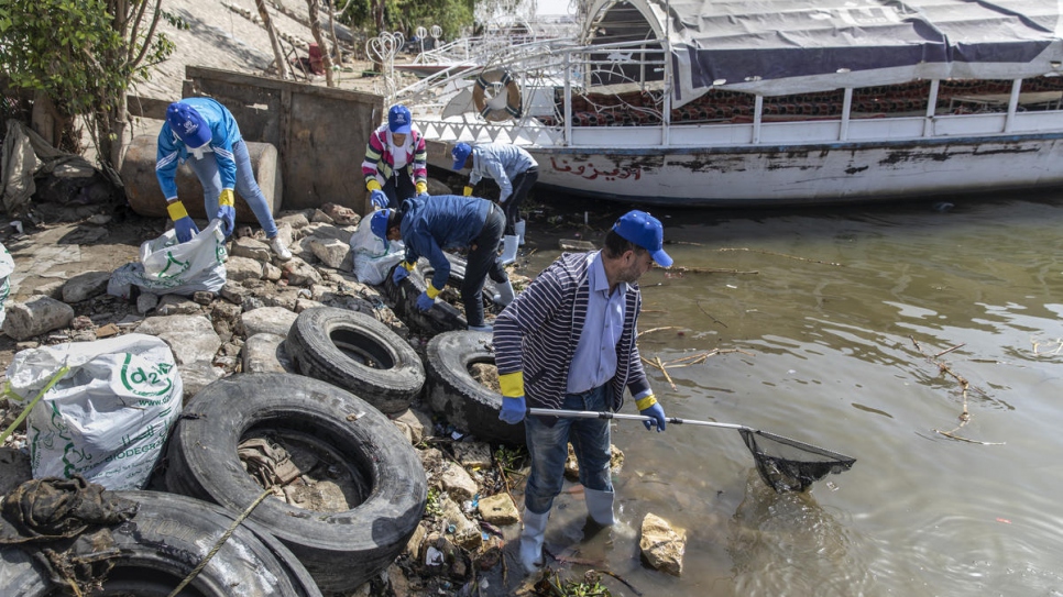 Refugee volunteers joined forces with locals to assist in the clean-up effort.