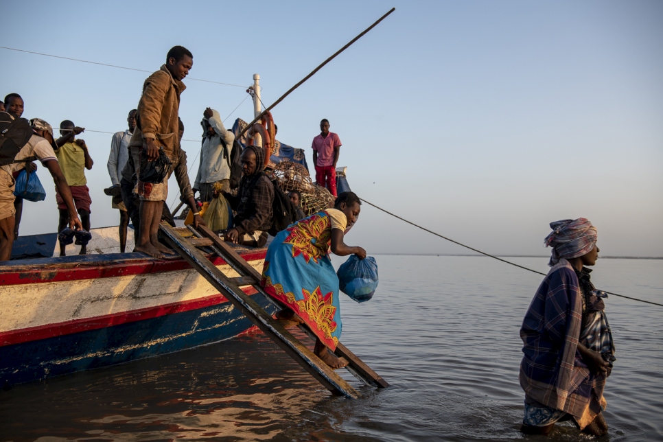 People displaced by Cyclone Idai disembark a boat at dawn in the port of Beira. Finding their homes destroyed, and belongings gone, many people have fled to Beira to seek international assistance.