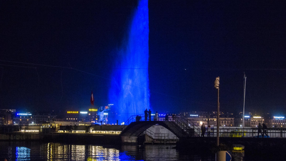 View of the famous Jet d'eau, symbol of the city, illuminated in blue for the GRF