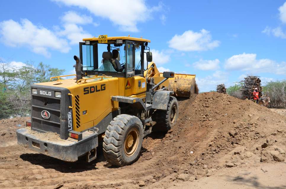 As part of camp cleaning exercise, a backhoe is filling a dumpsite and digging a new one in Dagahaley camp of Dadaab. UNHCR and its partner agencies have been carrying out soap distribution and hygiene promotion campaign in the five Dadaab camps.