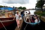 Boats used by refugees to reach safety in Europe are now being repurposed as tour boats on the canals of Amsterdam, with refugees serving as guides. The "Mister Friday" (left) once carried 282 refugees and migrants across the Mediterranean, while "Hedir" (right), meaning "Stormy Weather," carried 76.