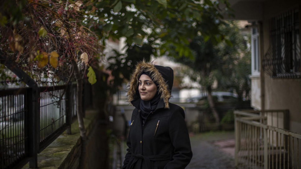 Sidra stands outside her home in Canda Sok on the outskirts of Istanbul.