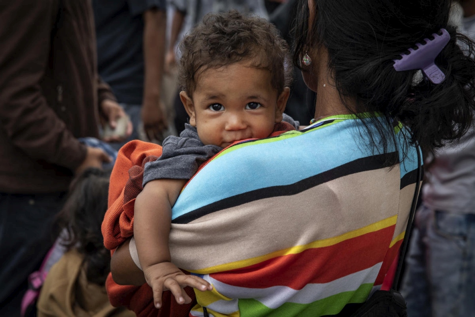 Colombia. A mother with her child crosses the Simon Bolivar Bridge, one of 7 legal entry points on the Colombia-Venezuela border