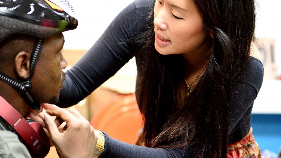 Helping with a helmet at The Bike Project 