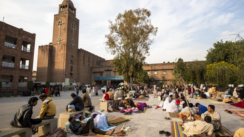 Relatives of patients wait outside Holy Family Hospital, in Rawalpindi, Pakistan.  
