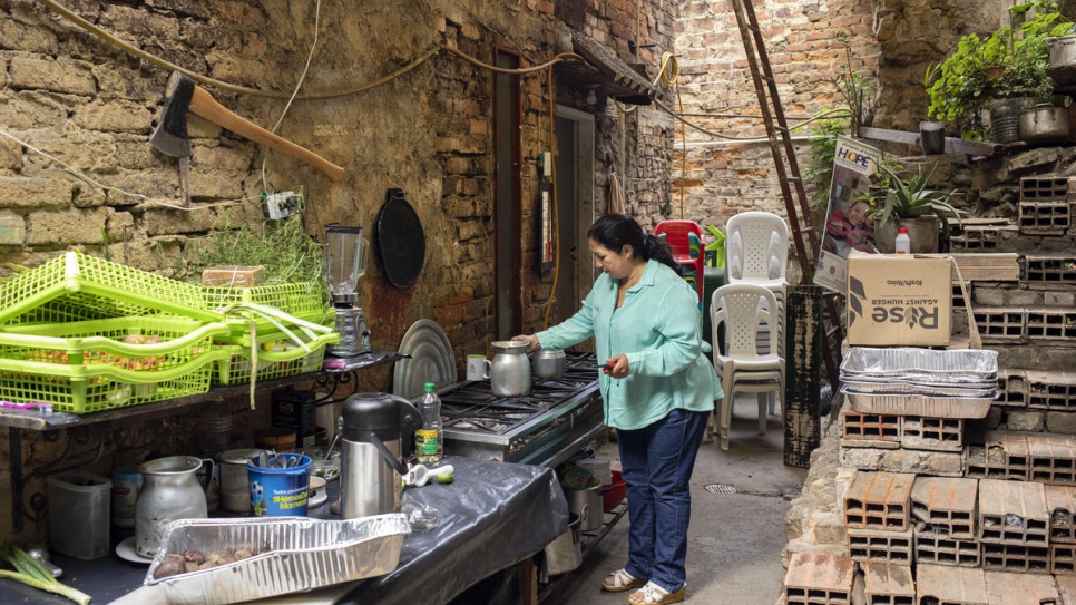 Marta Duque prepares breakfast in the yard of her home in Pamplona, Colombia.