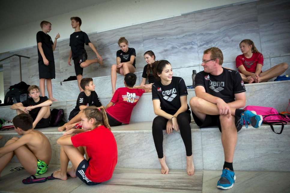 Yusra talks to her coach during a training session at her swimming club in Berlin.