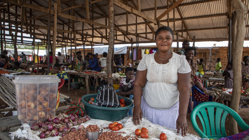  Mukea Chungu, a refugee from DRC,  stands at a  market stall in Mantapala settlement, Zambia. 