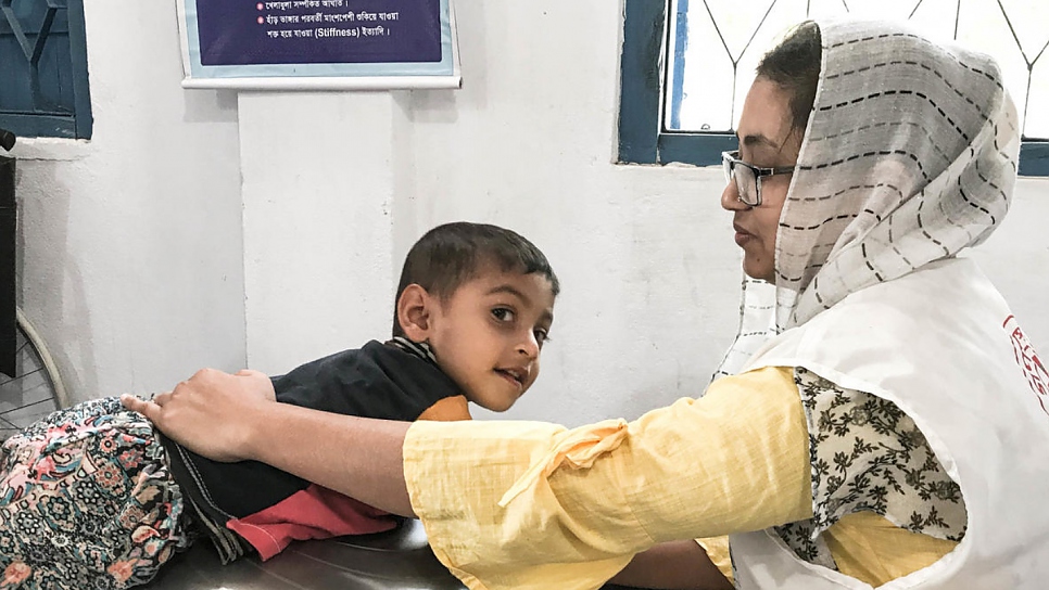 Through therapy she receives at the clinic, Aisha is now able to sit and walk with the aid of a walker.