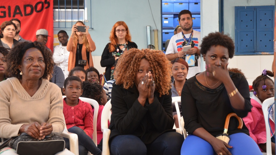 Nervous Congolese refugees watch Popole Misenga's Olympic judo bout.