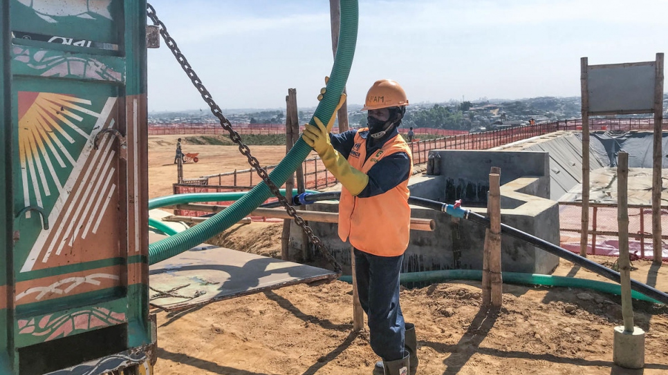 A worker empties sewage for treatment at a plant in Kutupalong refugee settlement, Bangladesh. The facility is the largest of its kind ever built in a refugee camp. 