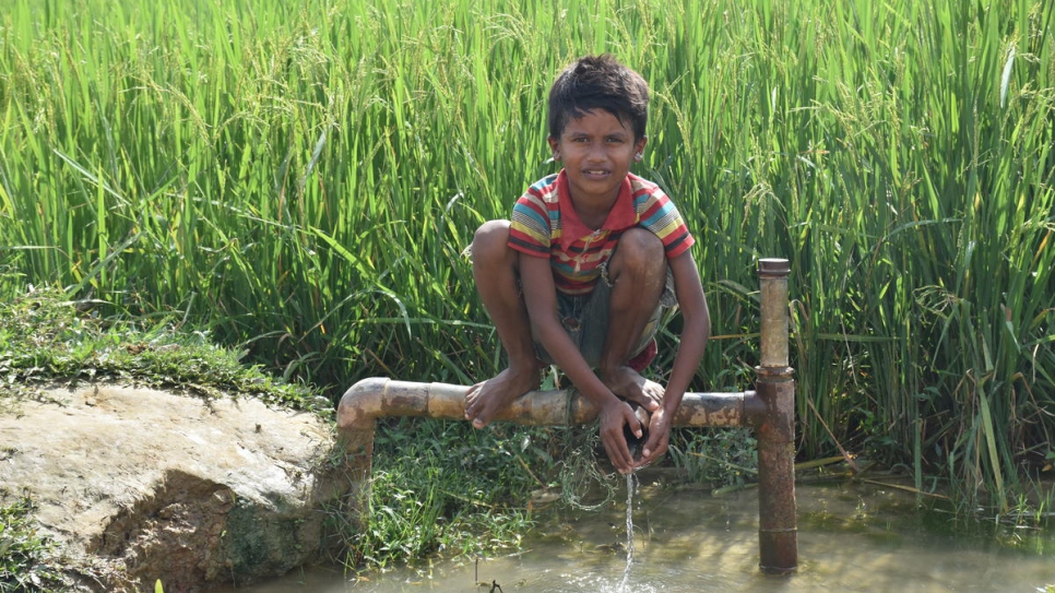 A young Rohingya boy sits on a water pipe in Chakmakul refugee settlement in southern Bangladesh. 