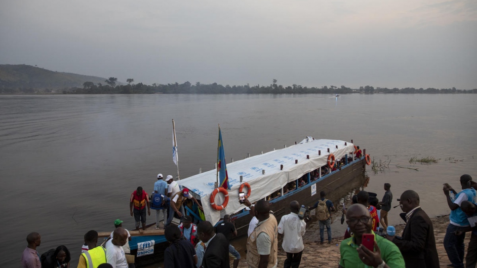 A boat carrying 200 voluntary returnees from the Democratic Republic of the Congo arrives in Bangui, the Central African Republic