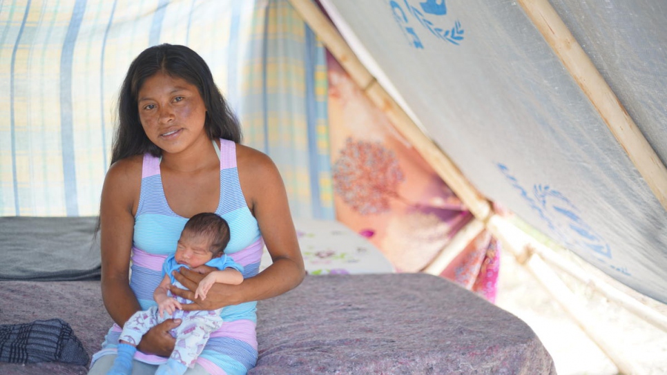 Magdalena, 21, with baby Neymar who was born just days after she was forced to flee.
