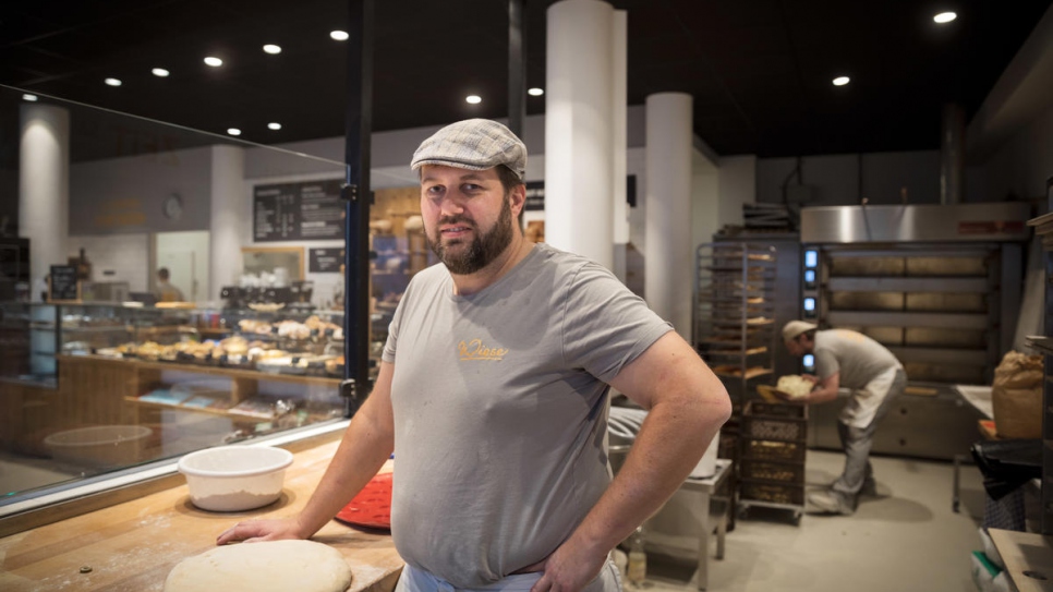 Björn prepares to bake bread in the kitchen that adjoins the shop.