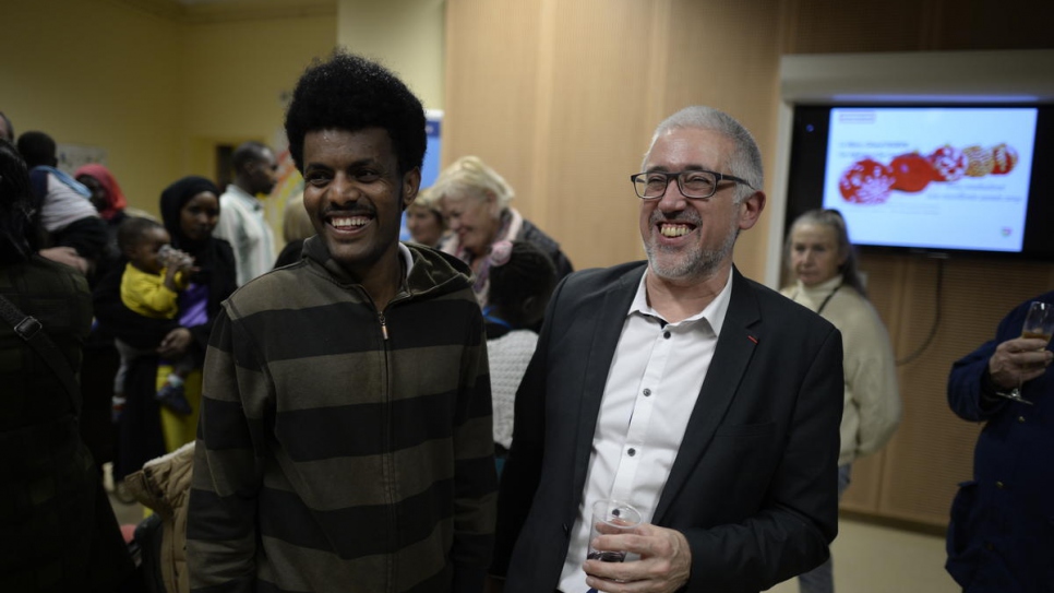 Mayor Gerard Dubois meets with refugees at City Hall.