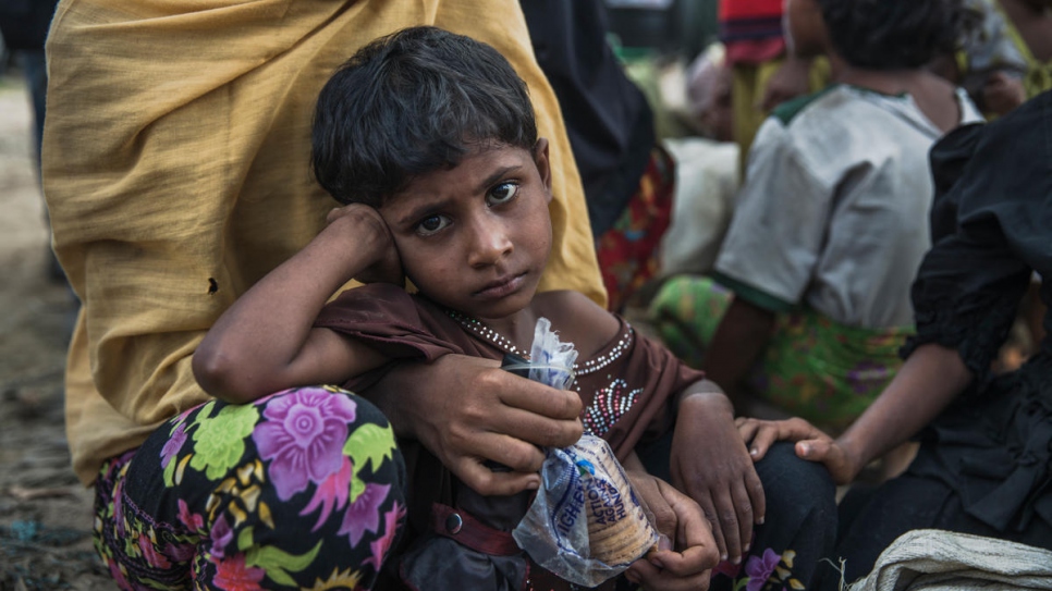 Noor Kalima, 4, rests after walking 10 kilometres from Myanmar to Kutupalong. Noor's parents were killed when their village was attacked. Both she and her sister are being cared for by their aunt, Rabiaa Khatun, who is 18.