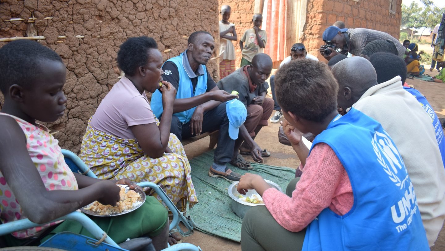 Sahring a meal with refugee Community